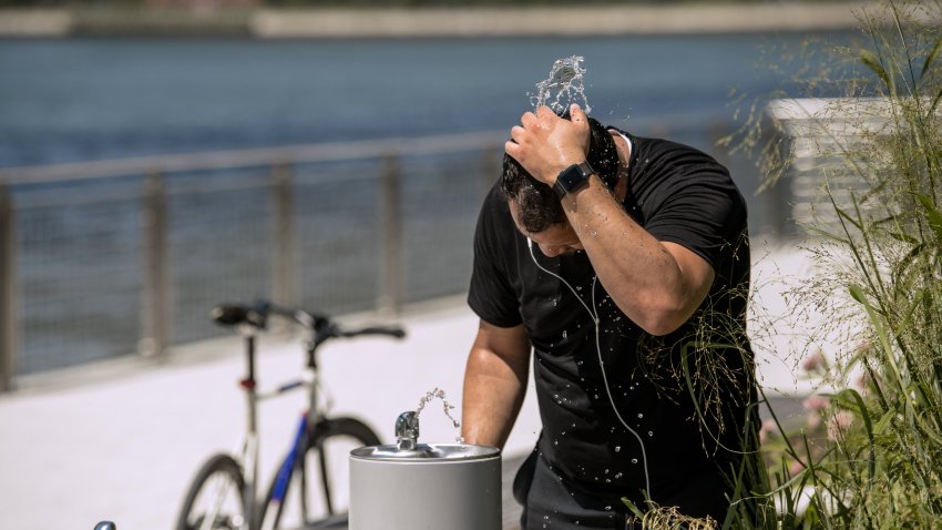 Man splashes head with water