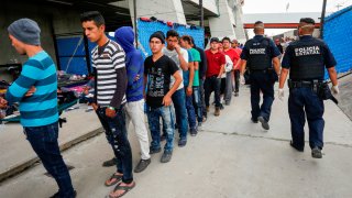 Fila de migrantes en estación en México