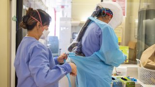 nurses prepare their personal protective equipment