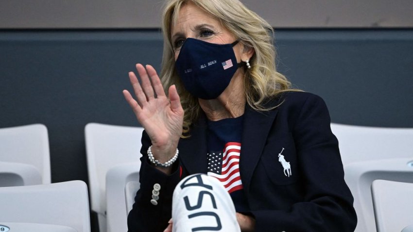 US First Lady Jill Biden waves as she attends a swimming event during the Tokyo 2020 Olympic Games at the Tokyo Aquatics Centre in Tokyo on July 24, 2021. (Photo by Jonathan NACKSTRAND / AFP) (Photo by JONATHAN NACKSTRAND/AFP via Getty Images)