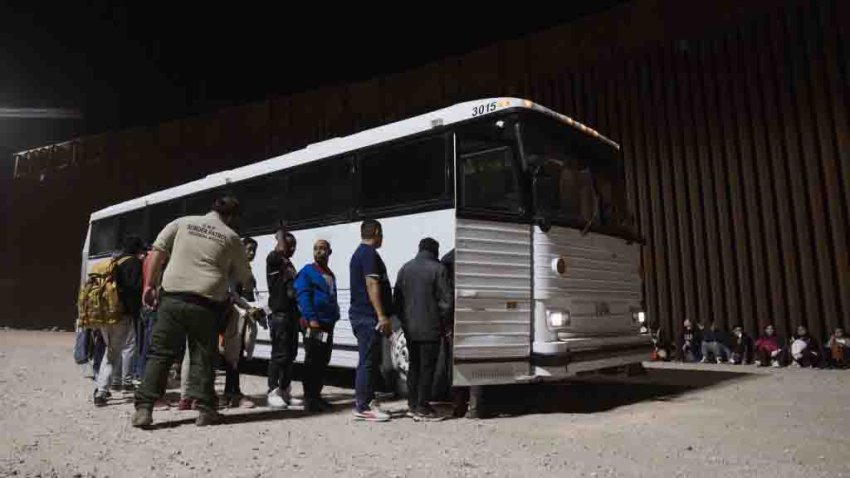 Migrants board a bus after surrendering to US Border Patrol agents at the US-Mexico border at the lifting of Title 42 in Yuma, Arizona, US, on Thursday, May 11, 2023. Tumultuous conditions are anticipated at the US-Mexico border after pandemic-era immigration restrictions were lifted Thursday night. Photographer: Eric Thayer/Bloomberg via Getty Images