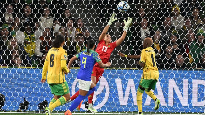 Jamaica’s goalkeeper #13 Rebecca Spencer makes a save in front of Jamaica’s midfielder #08 Drew Spence (L), Brazil’s forward #09 Debinha and Jamaica’s defender #14 Deneisha Blackwood during the Australia and New Zealand 2023 Women’s World Cup Group F football match between Jamaica and Brazil at Melbourne Rectangular Stadium, also known as AAMI Park, in Melbourne on August 2, 2023. (Photo by WILLIAM WEST / AFP) (Photo by WILLIAM WEST/AFP via Getty Images)