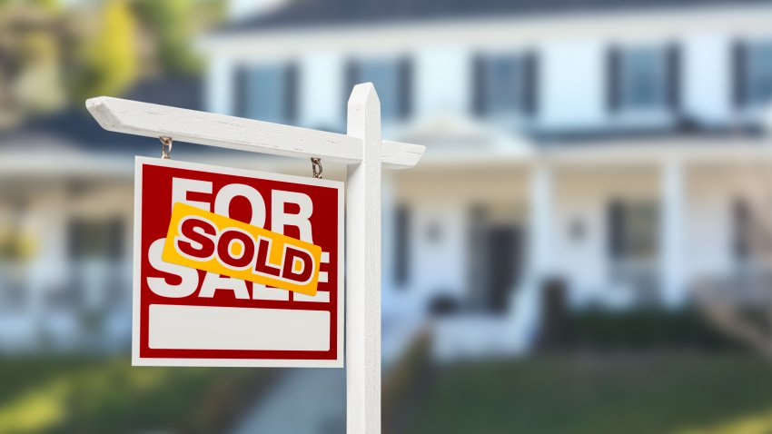 Sold Home For Sale Real Estate Sign in Front of Beautiful New House.