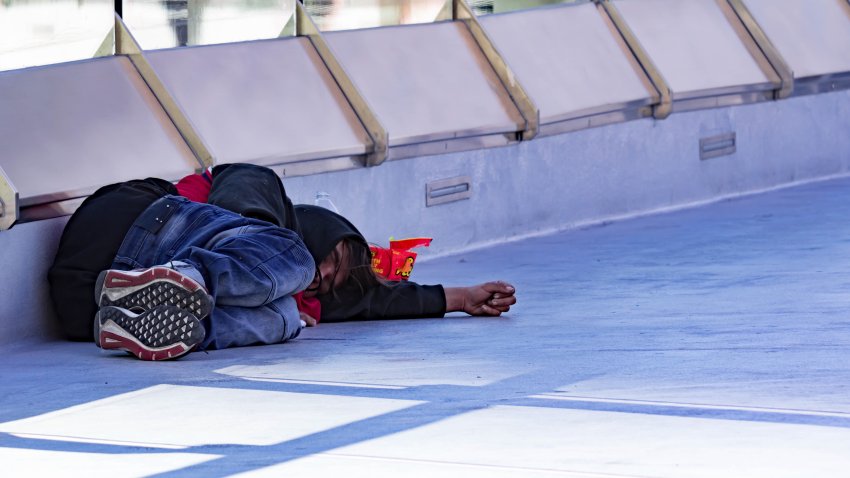 Homeless Person sleeping on a bridge near Hard Rock Cafe Las Vegas Strip, Las Vegas Nevada USA, March 30, 2020