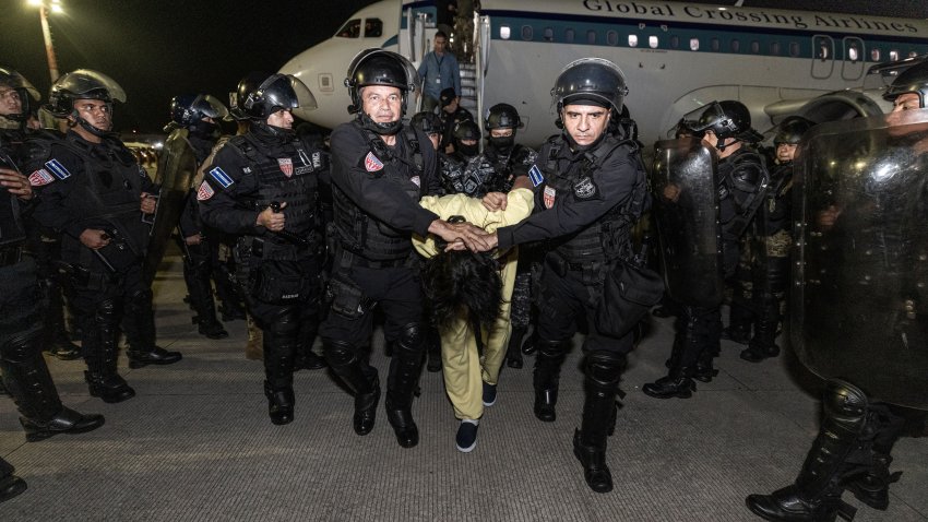 TECOLUCA, EL SALVADOR – MARCH 16: In this handout photo provided by the Salvadoran government,  guards escort a newly admitted inmate allegedly linked to criminal organizations at CECOT on March 16, 2025 in Tecoluca, El Salvador. Trump’s administration deported 238 alleged members of the Venezuelan criminal organizations ‘Tren De Aragua’ and Mara Salvatrucha with only 23 being members of the Mara. Nayib Bukele president of El Salvador announced that his government will receive the alleged members of the gang to be taken to CECOT. On February of 2023 El Salvador inaugurated Latin America’s largest prison as part of President Nayib Bukele’s plan to fight gangs. (Photo by Salvadoran Government via Getty Images)