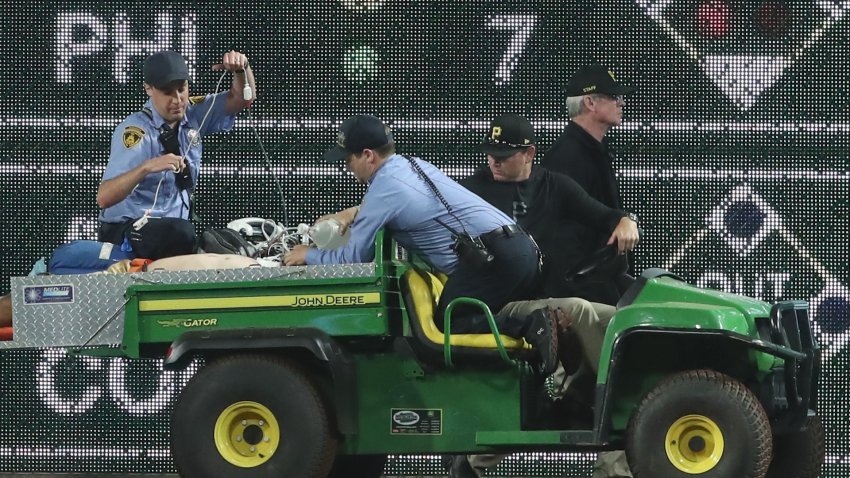 A fan is removed from the stadium on a stretcher