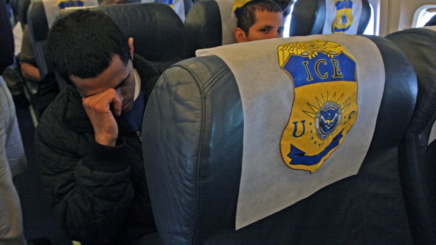 Under strict surveillance by US immigration and customs officers, Salvadorean illegal immigrants doze as they fly over Mexican airspace on their way back to El Salvador, deported from the United States, on December 18, 2008.  Today, 116 Salvadorean nationals –83 men and 33 women– were woken up at 4 a.m. and transported in buses under strict surveillance to the airport to be deported to El Salvador.  AFP PHOTO/ Jose CABEZAS (Photo by Jose CABEZAS / AFP) (Photo by JOSE CABEZAS/AFP via Getty Images)
