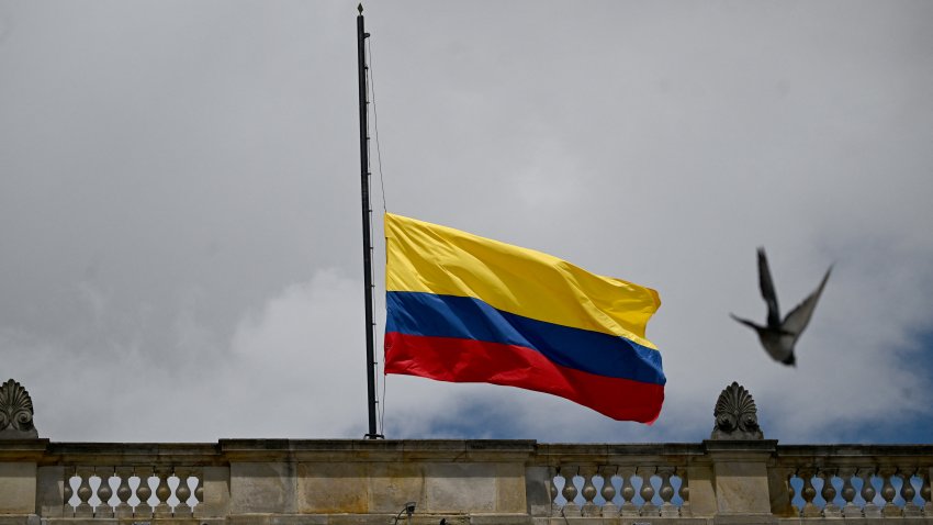 A Colombian national flag flies at half-mast outside Congress following the death of Colombian presidential candidate Miguel Uribe, in Bogota, on August 11, 2025. Colombian presidential candidate Miguel Uribe died two months after being shot in the head at a campaign event, his wife announced early August 11, 2025. The legislator’s condition had returned to critical after he suffered a new brain hemorrhage related to the assassination attempt during a rally on June 7, in which he was shot three times, twice in the head. (Photo by Raul ARBOLEDA / AFP) (Photo by RAUL ARBOLEDA/AFP via Getty Images)