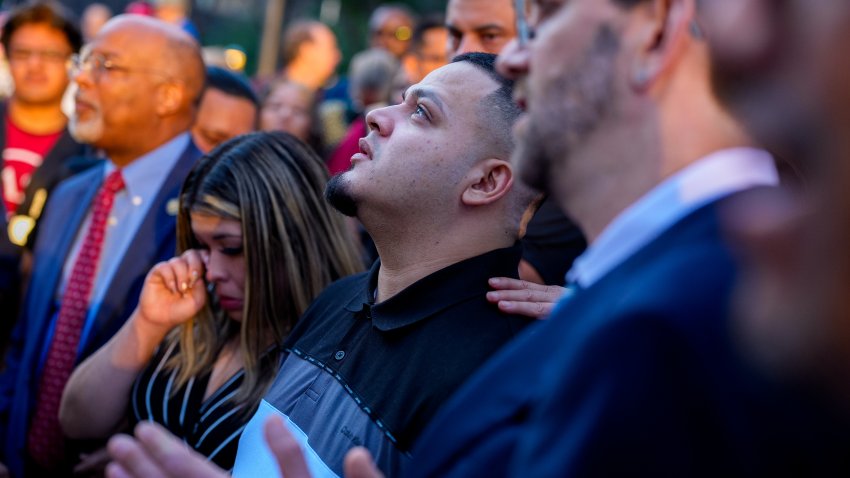 BALTIMORE, MARYLAND – AUGUST 25: Kilmar Abrego Garcia (C), accompanied by his wife Jennifer Vasquez Sura (L), looks up after a prayer vigil before he enters a U.S. Immigration and Customs Enforcement (ICE) field office on August 25, 2025 in Baltimore, Maryland. The U.S. Government is threatening to deport Garcia, a Maryland construction worker from El Salvador, to Uganda after he rejected a plea deal to be charged with Human Smuggling and deported to Costa Rica. Earlier this year Garcia was wrongfully deported to a notorious anti-terrorism prison CECOT in El Salvador. (Photo by Andrew Harnik/Getty Images)